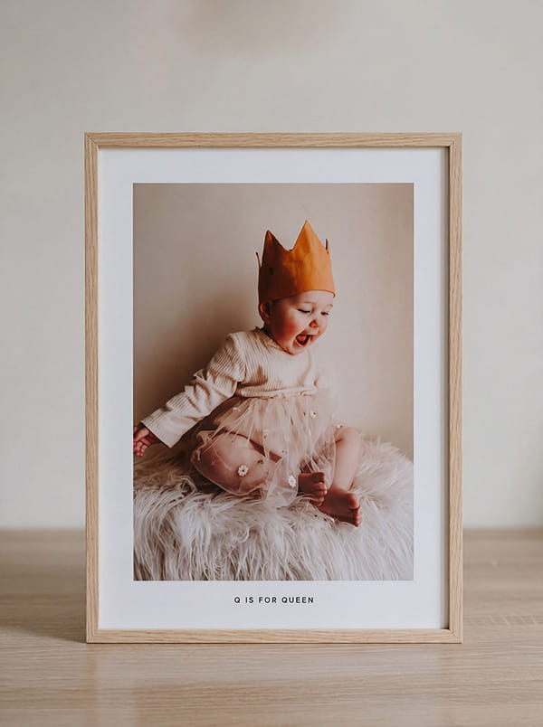Baby wearing a crown and tulle skirt, smiling joyfully