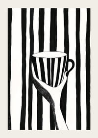 A hand holds a striped cup in black and white pattern-3