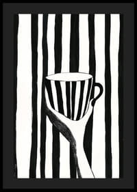 A hand holds a striped cup in black and white pattern-4