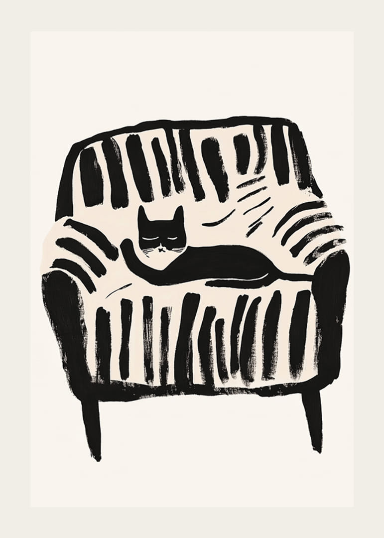 A black and white cat rests peacefully in the soft lines of the armchair-12