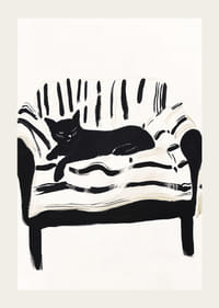 En katt ligger lugnt på en randig soffa och skapar en harmonisk känsla-3