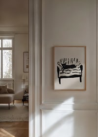 A cat lies calmly on a striped sofa, creating a harmonious feeling-8