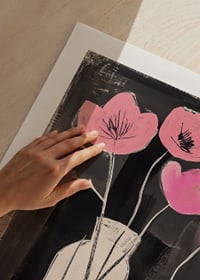 Elegant pink flowers contrast against a deep black background-9