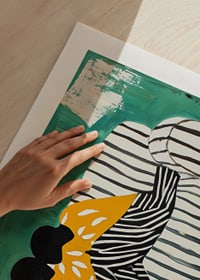 Two figures in a soft embrace on a striped sofa against a green background-9