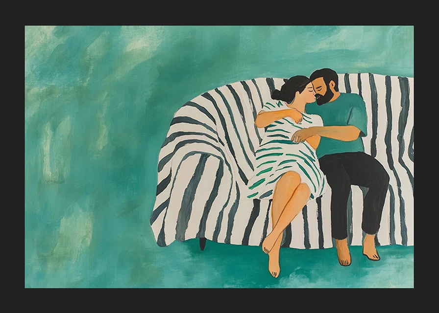 A couple rests together on a striped sofa, filled with harmony-12