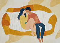 A loving couple rests on a stylized sofa in soft tones-3