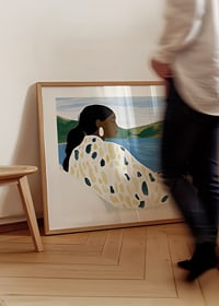 A woman rests by a peaceful lake with soft colors-8
