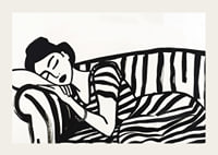 She rests dreamily on a striped sofa in monochrome elegance.-3