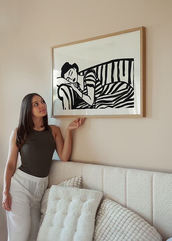 She rests dreamily on a striped sofa in monochrome elegance.-12