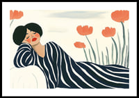 A woman rests in striped clothes surrounded by orange flowers-0