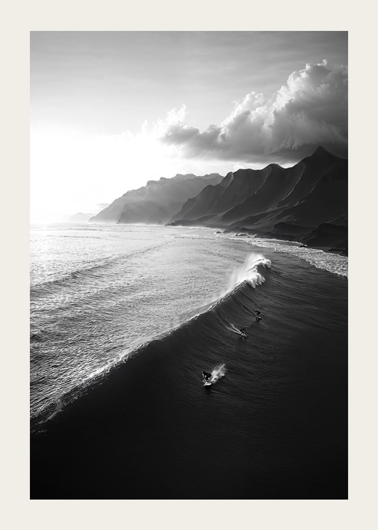 Black and white poster with surfers riding powerful waves on a dramatic coastline-12