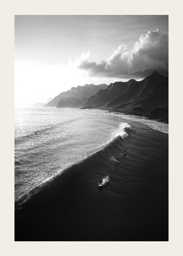 Black and white poster with surfers riding powerful waves on a dramatic coastline-12