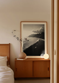 Black and white poster with surfers riding powerful waves on a dramatic coastline-8