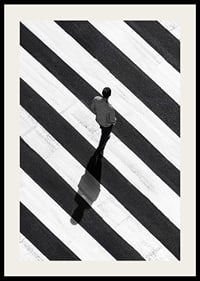 A man walks across a striped crosswalk in black and white-2
