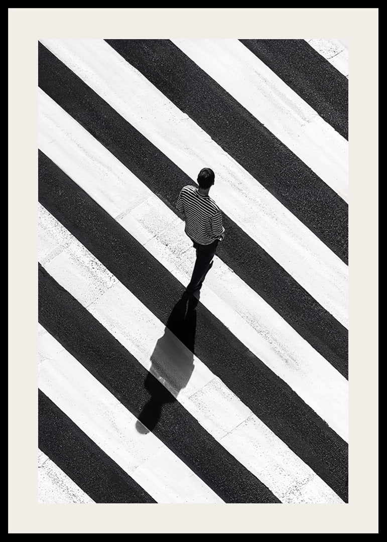 A man walks across a striped crosswalk in black and white-12