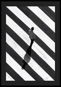 A man walks across a striped crosswalk in black and white-4