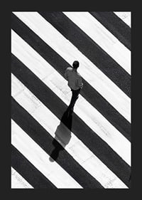 A man walks across a striped crosswalk in black and white-5