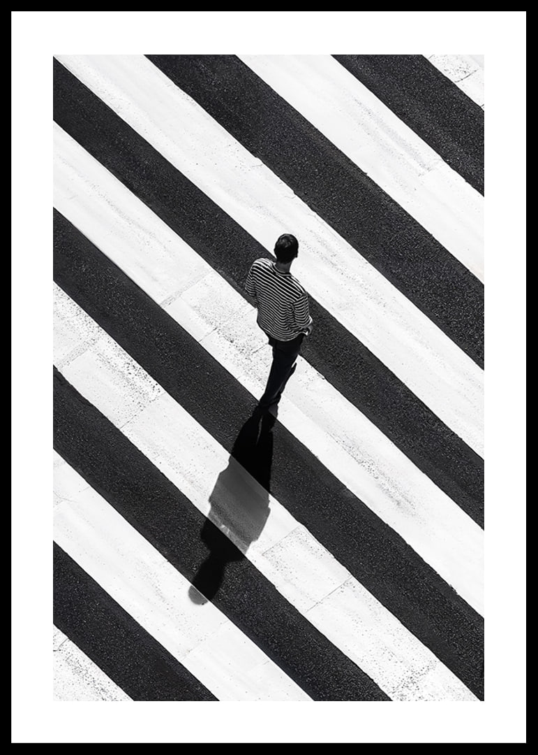 A man walks across a striped crosswalk in black and white-12