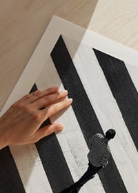 A man walks across a striped crosswalk in black and white-9