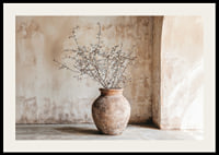 A rustic pot with twigs against a softly patinated wall-2