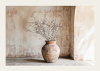 A rustic pot with twigs against a softly patinated wall-3