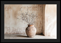 A rustic pot with twigs against a softly patinated wall-4