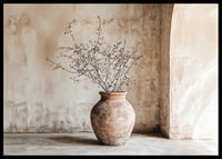 A rustic pot with twigs against a softly patinated wall-6