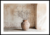 A rustic pot with twigs against a softly patinated wall-0