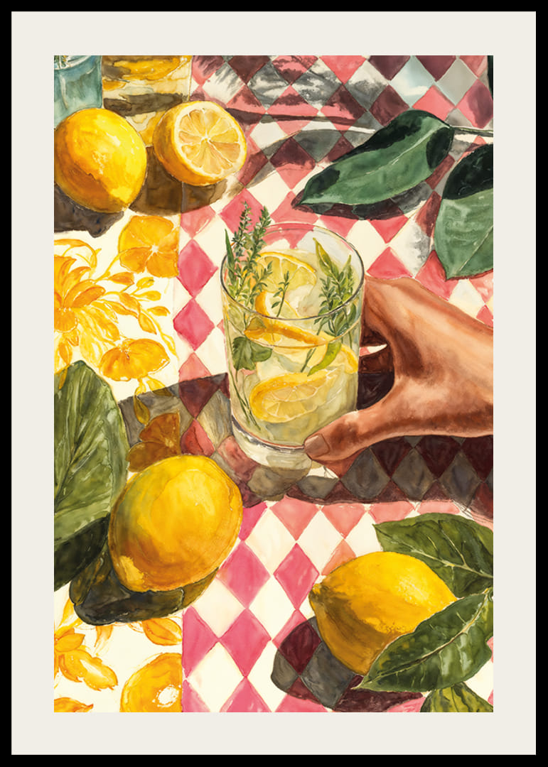 A hand enjoying a fresh lemon drink on a colorful table-12