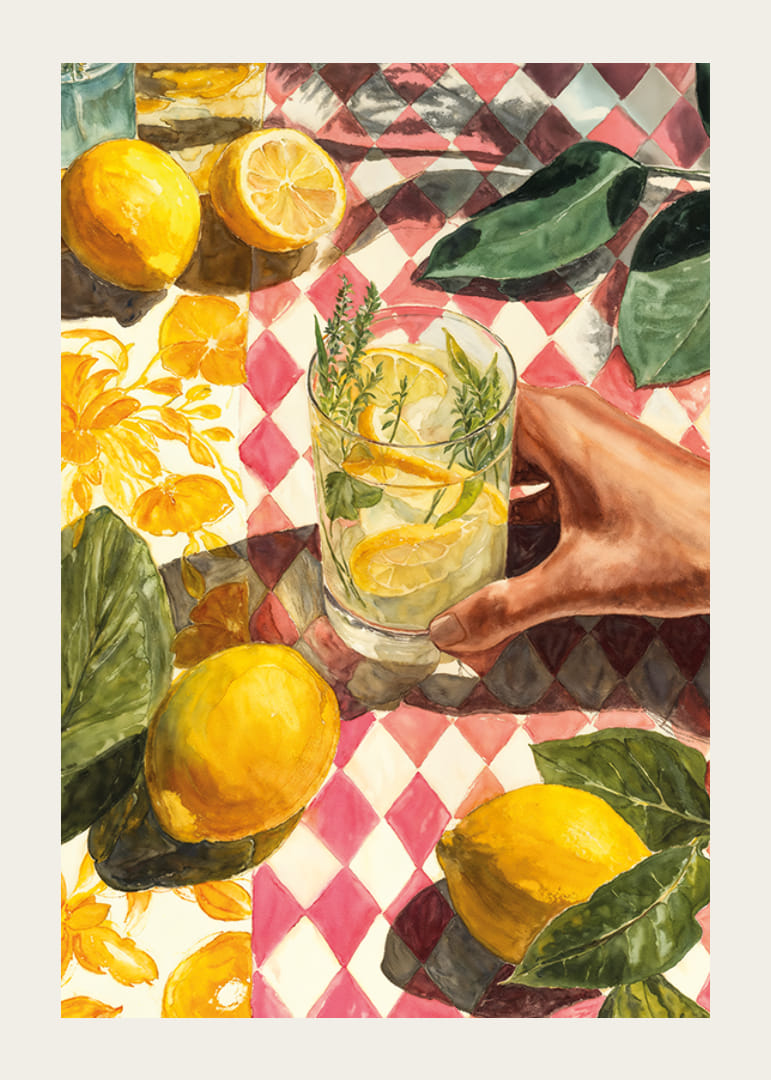 A hand enjoying a fresh lemon drink on a colorful table-12