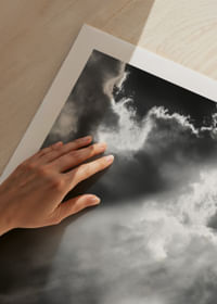 A lone horse stands silhouetted on a hill under dramatic rays of light through the clouds.-5