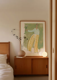 A dancing figure with flowers spreads joy in soft colors.-4