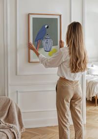 A parrot proudly guarding a wintry, beautiful ceramic jug.-4