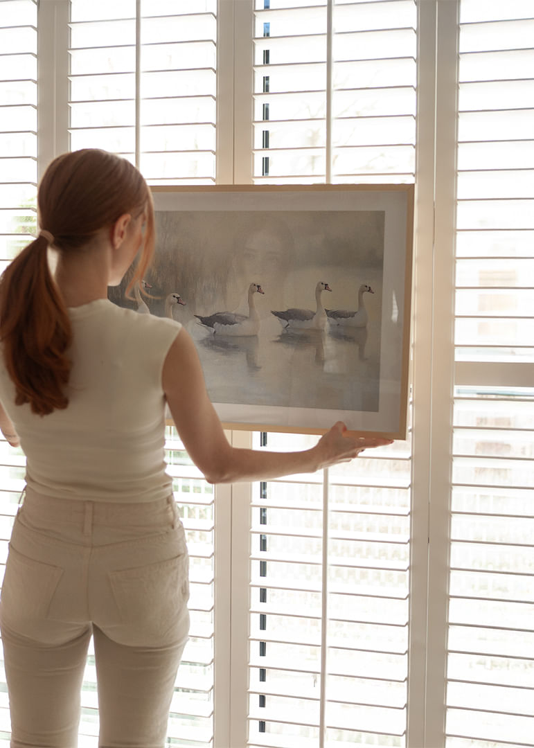 Five white swans glide gracefully on the mirror-like lake.-12