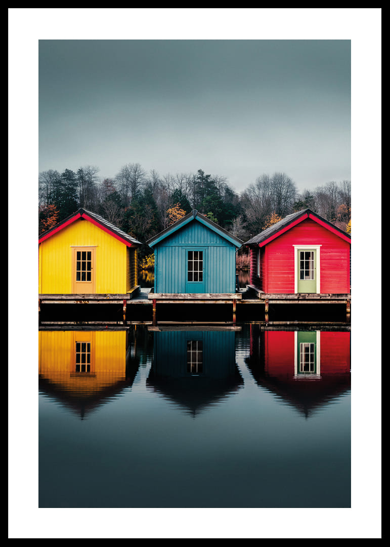 Three colorful houses are reflected in calm water, creating harmony.-12