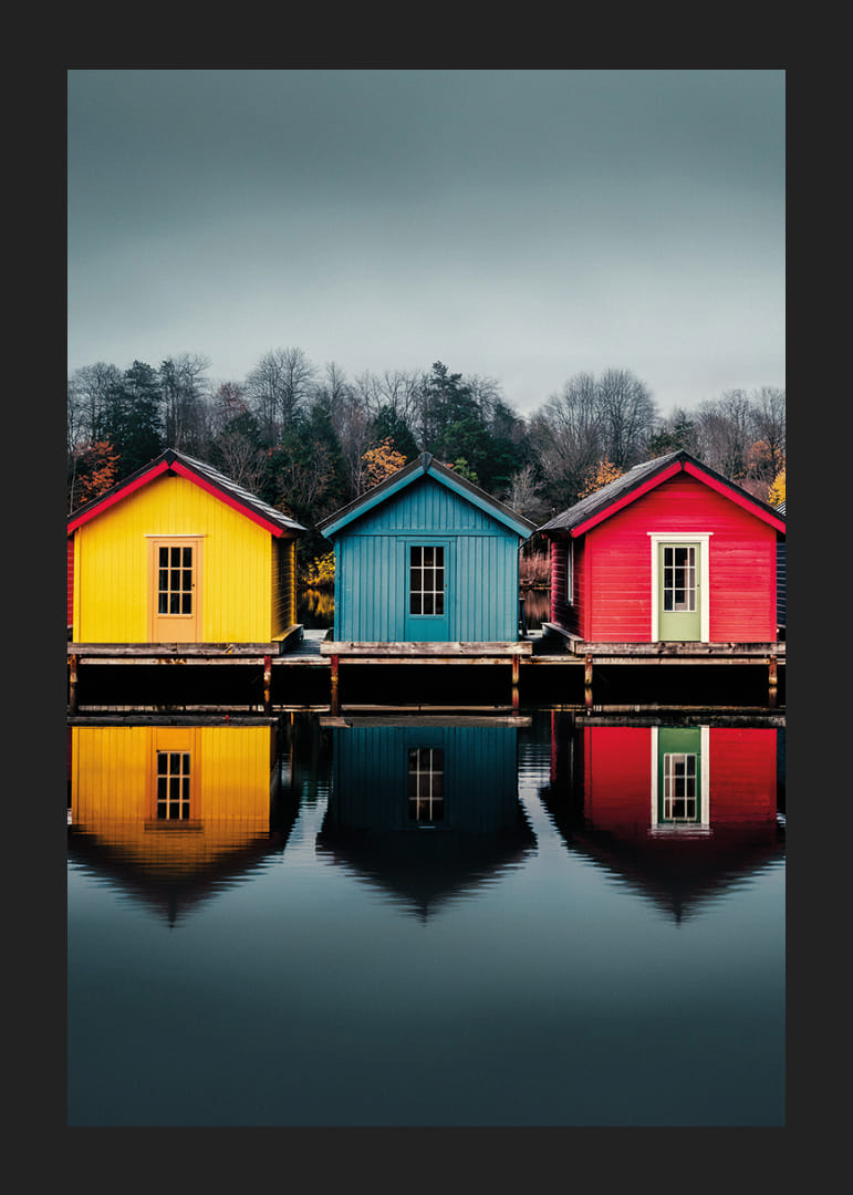 Three colorful houses are reflected in calm water, creating harmony.-12