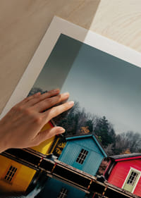 Three colorful houses are reflected in calm water, creating harmony.-9