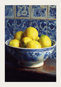 Fresh lemons in a blue and white bowl against tiled walls.-3