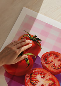 Juicy tomatoes shine on a checkered table.-9