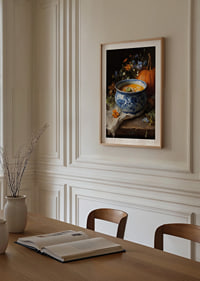 Bowl of creamy pumpkin soup surrounded by autumn flowers and a pumpkin.-8
