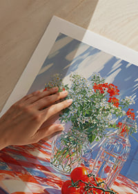 Sunshine over a red and white checkered tablecloth with flowers and tomatoes.-9