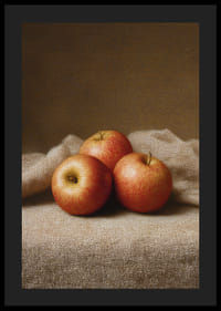 Three golden apples rest on a soft cloth.-4