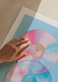 Deux disques vinyles scintillants aux tons pastel sur fond bleu.-5