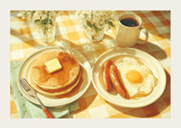 A sunny breakfast of pancakes and eggs in a warm atmosphere.-3