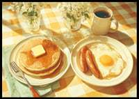 A sunny breakfast of pancakes and eggs in a warm atmosphere.-6