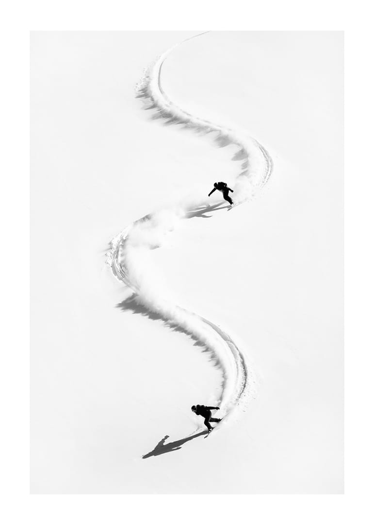 Two skiers meander through the white landscape of snow.-12