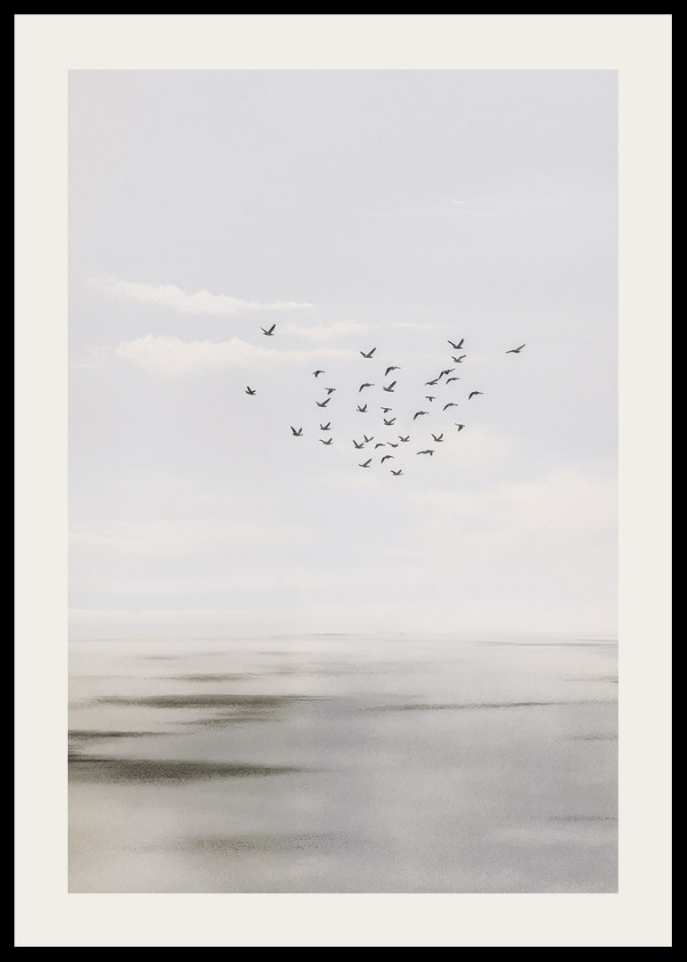 Birds soar in a soft sky over a calm sea.-12