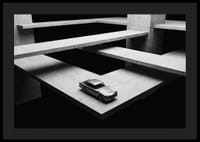 A classic Aston Martin DB5 hovers over the modern concrete landscape.-4