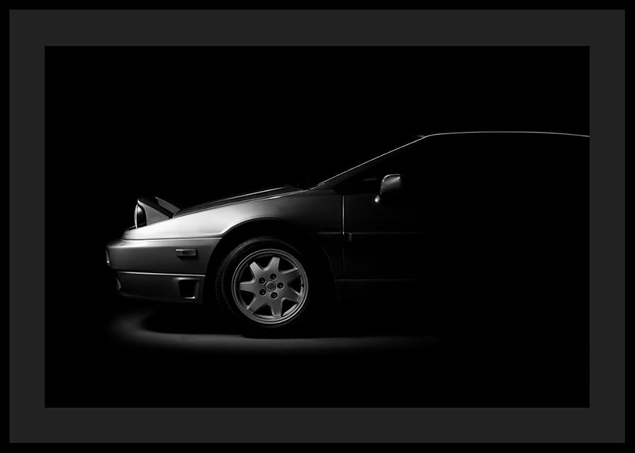 A Lotus Esprit shrouded in shadows exudes dramatic elegance.-12