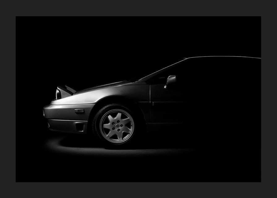 A Lotus Esprit shrouded in shadows exudes dramatic elegance.-12